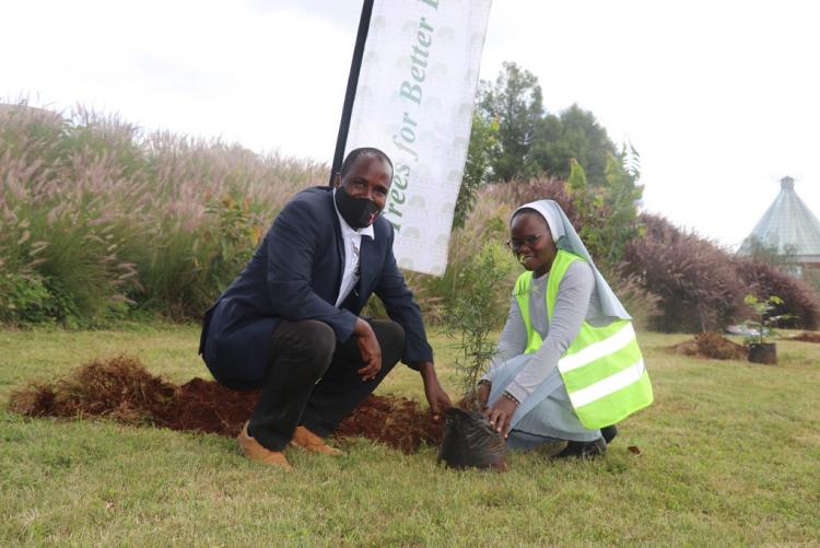 John Birir and Nanct Owili planting a tree in Wangari Mathai Ground